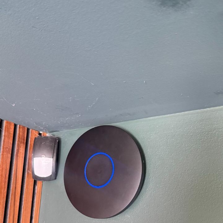 Ceiling mounted UniFi WiFi access point with illuminated status ring